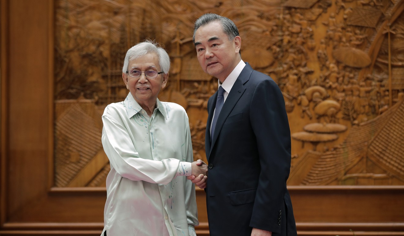 Malaysia’s government adviser Daim Zainuddin is in Beijing to finalise the future of the troubled East Coast Rail Link. He is pictured with China’s Foreign Minister Wang Yi in 2018. Photo: AFP