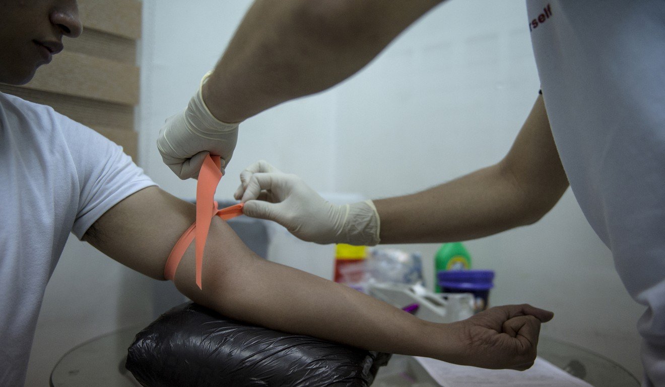 A man gets tested for HIV. A New Zealand teacher has launched a legal challenge against South Korea’s government after she lost her job for refusing to take a HIV test. Photo: AFP