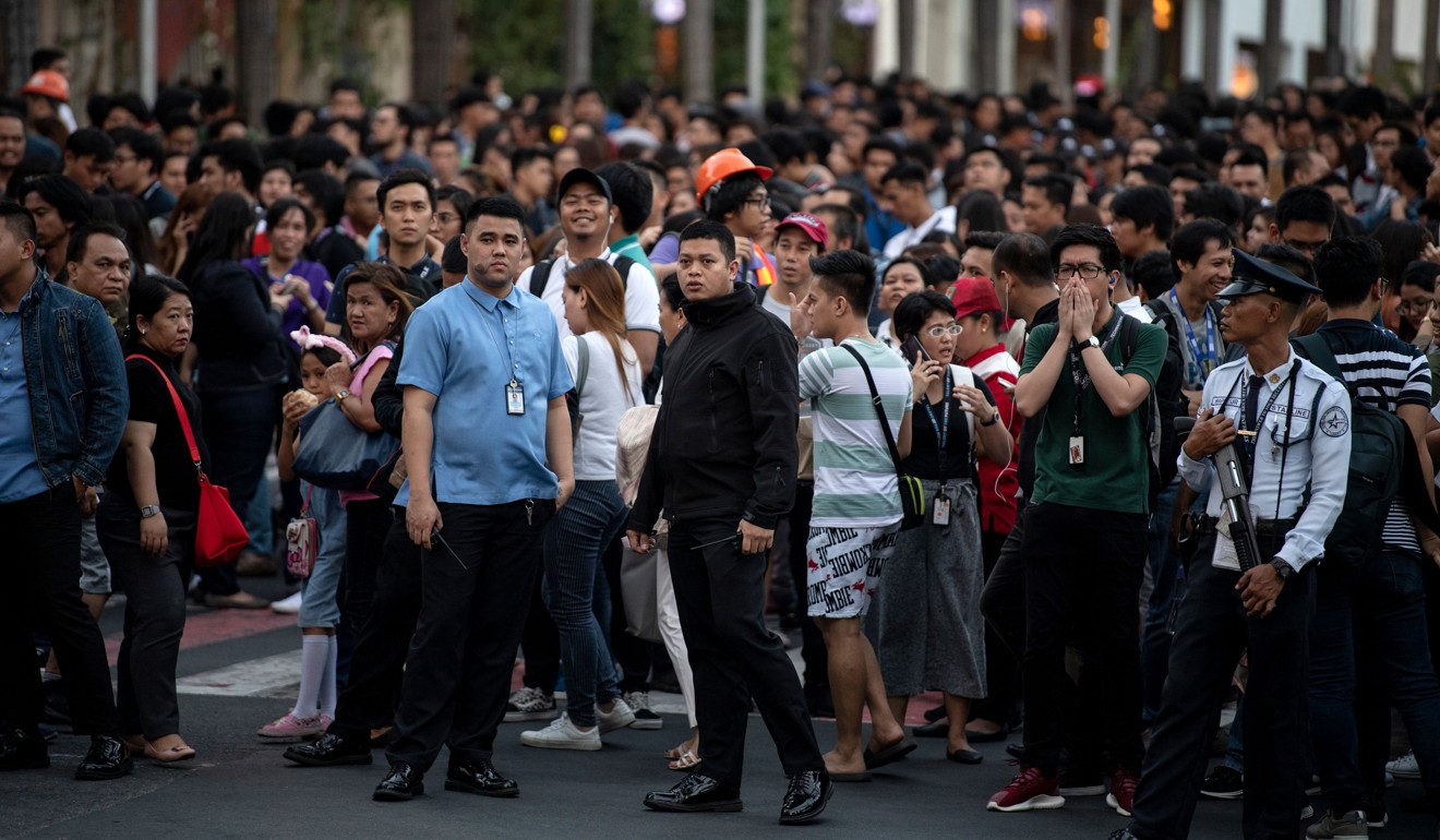 People at an open area in Manila after an earthquake rocked the Philippines on Monday. Photo: AFP