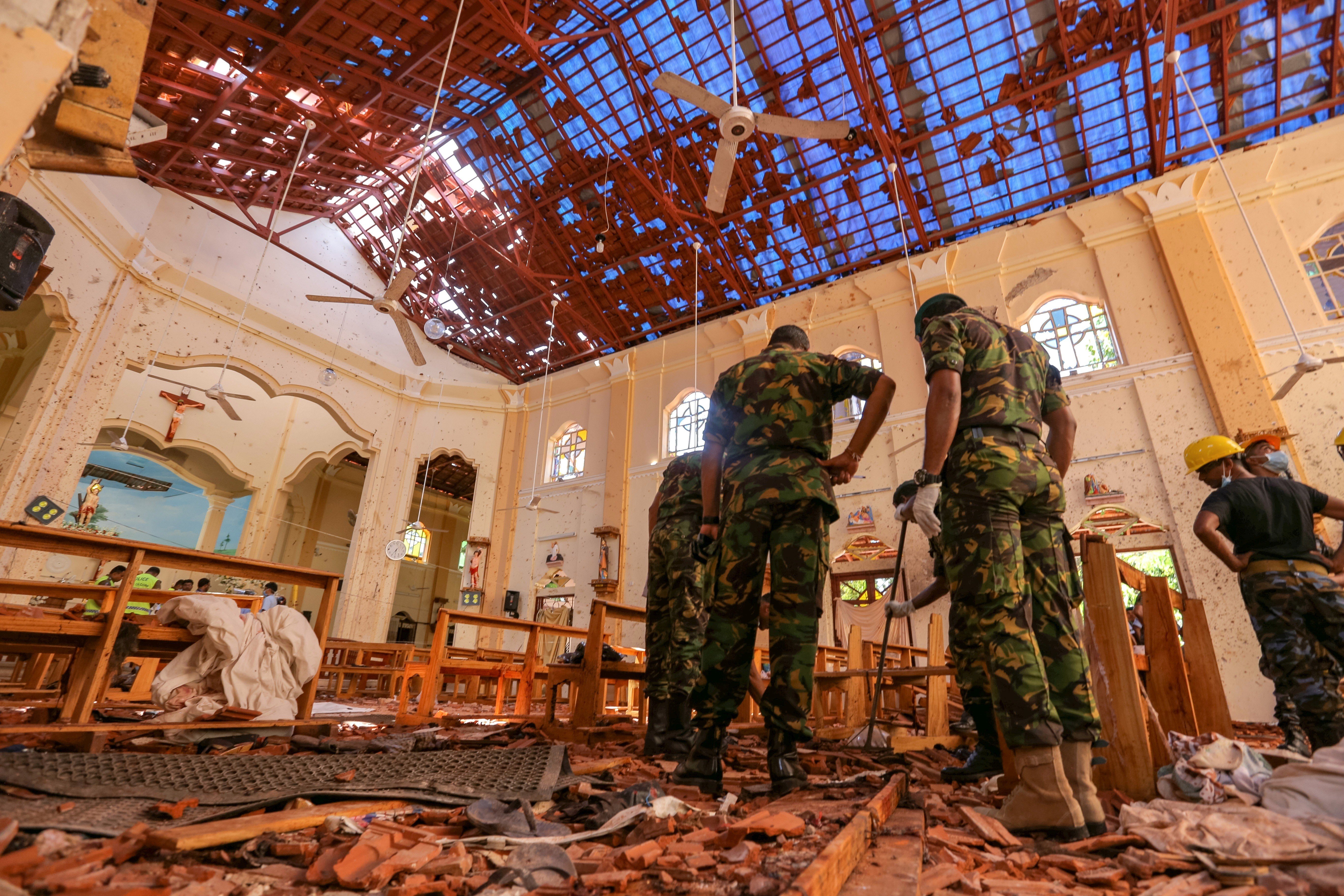 Sri Lankan soldiers inspect the damage following explosions at St. Sebastian's Church in Negombo. Photo: Bloomberg