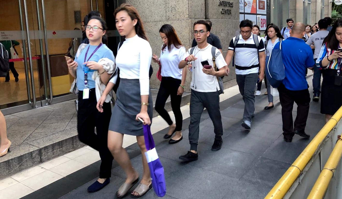 Employees are evacuated from their office buildings in Makati City, Philippines. Photo: Reuters