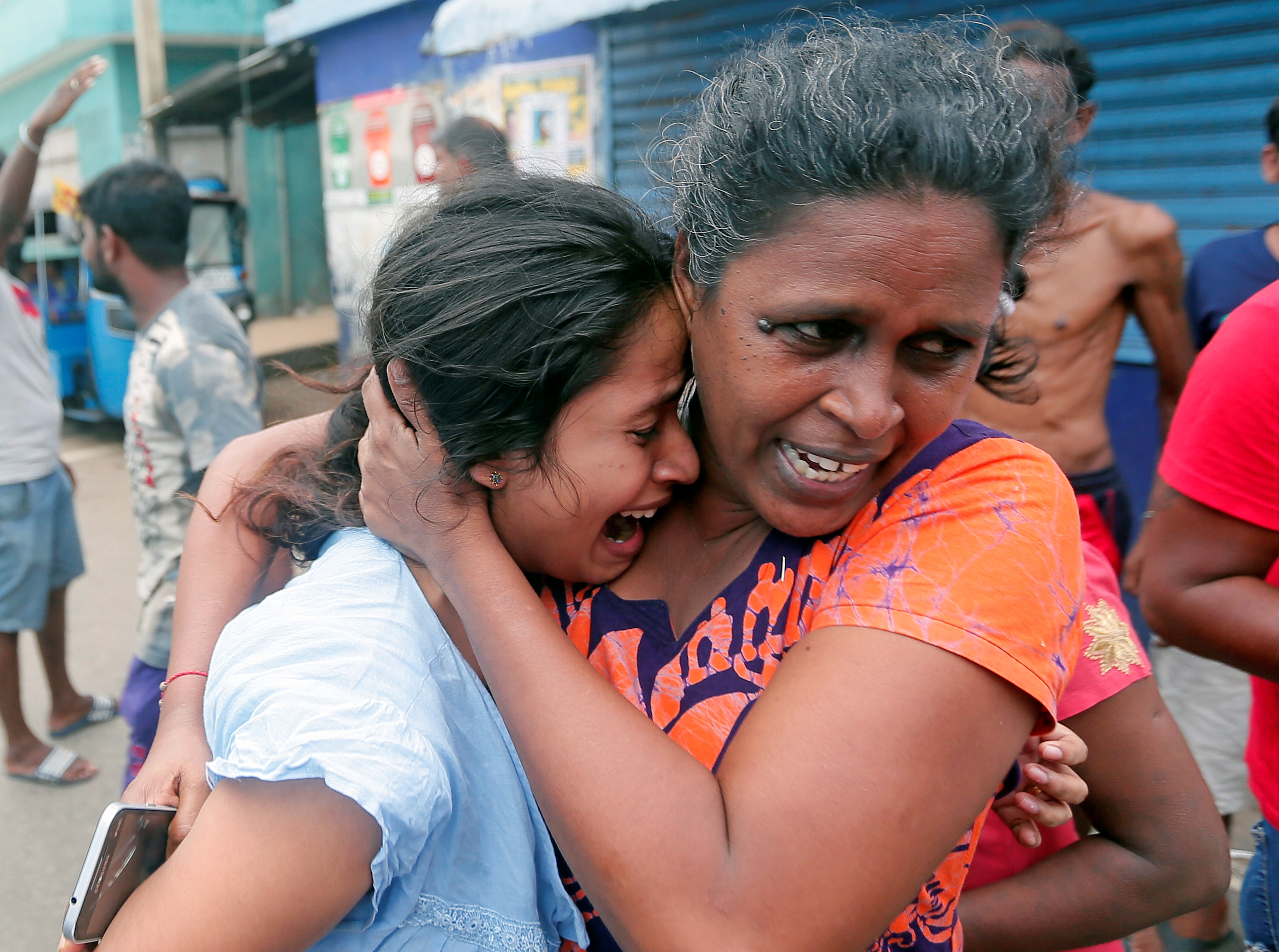 People leave their houses in fear as the military try to defuse a suspicious van in Colombo. Photo: Reuters