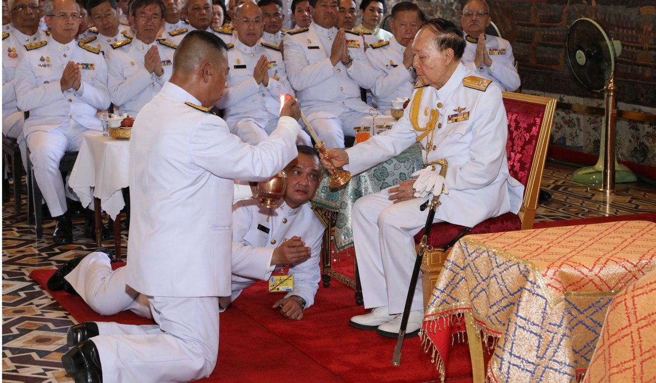Senior Thai royal family member Admiral M.C. Pusan Sawasdiwat (right) at a ritual on behalf of the King Maha Vajiralongkorn to inscribe the king’s name and title, cast the king's horoscope and engrave the king’s official seal at Wat Phra Kaew in Bangkok on Tuesday. Photo: Reuters