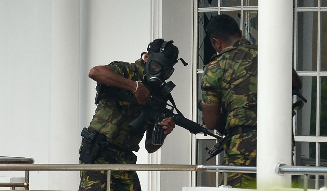 Sri Lankan Special Task Force (STF) personnel outside a house during a raid in which a suicide blast killed police searching the property in the capital Colombo. Photo: AFP