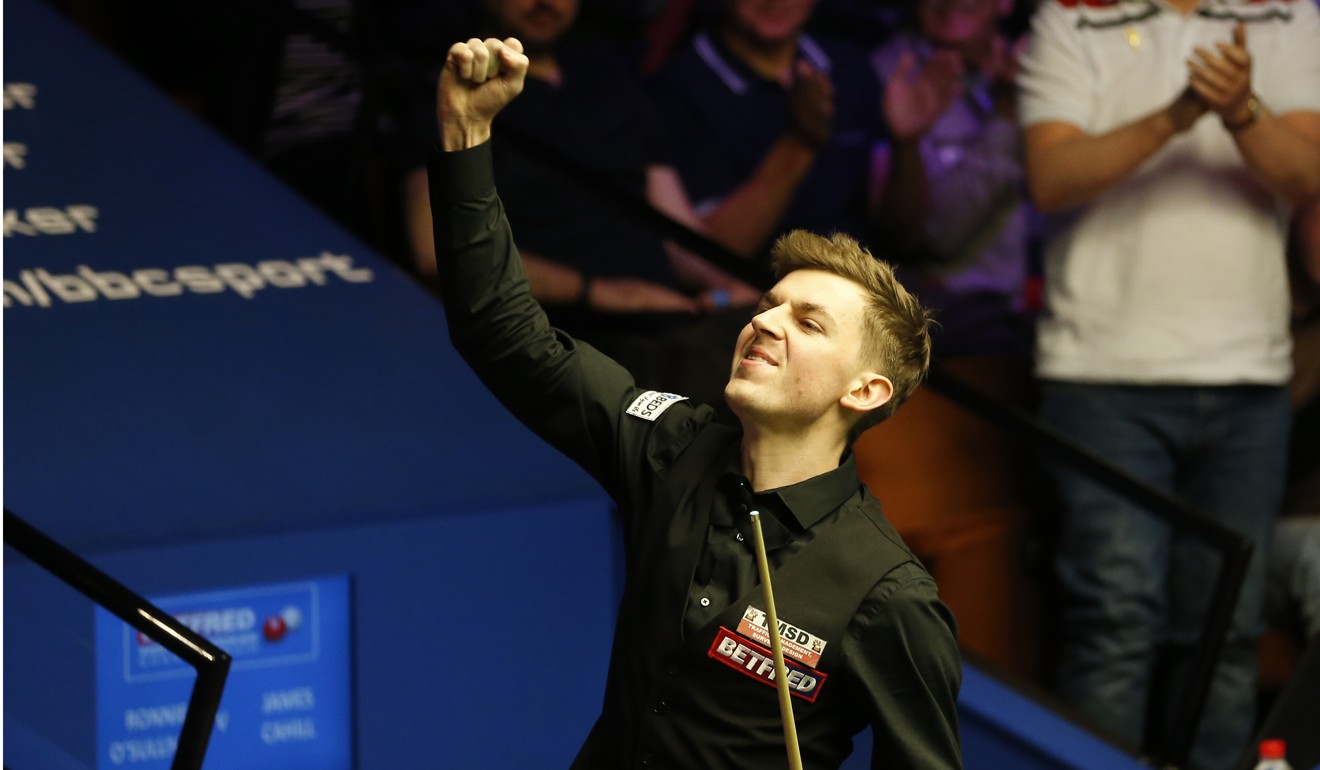 James Cahill celebrates after beating the best player of his generation at the Crucible. Photo: Xinhua