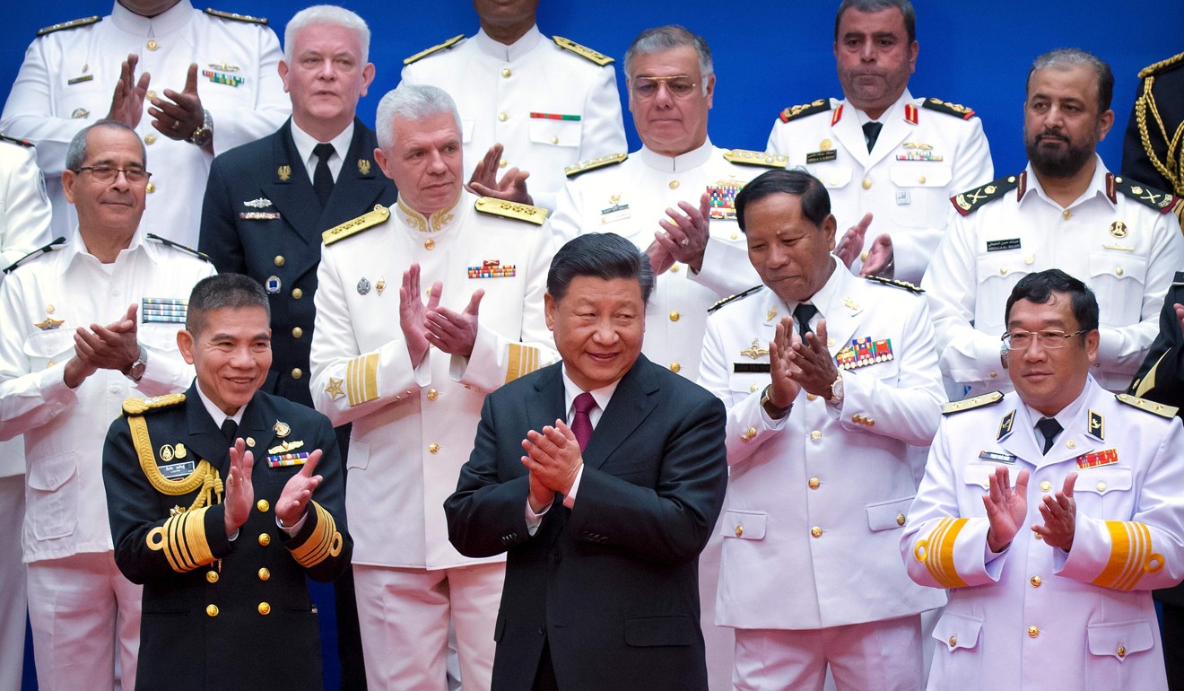 Chinese President Xi Jinping surrounded by Chinese and foreign naval commanders at the event. Photo: AFP