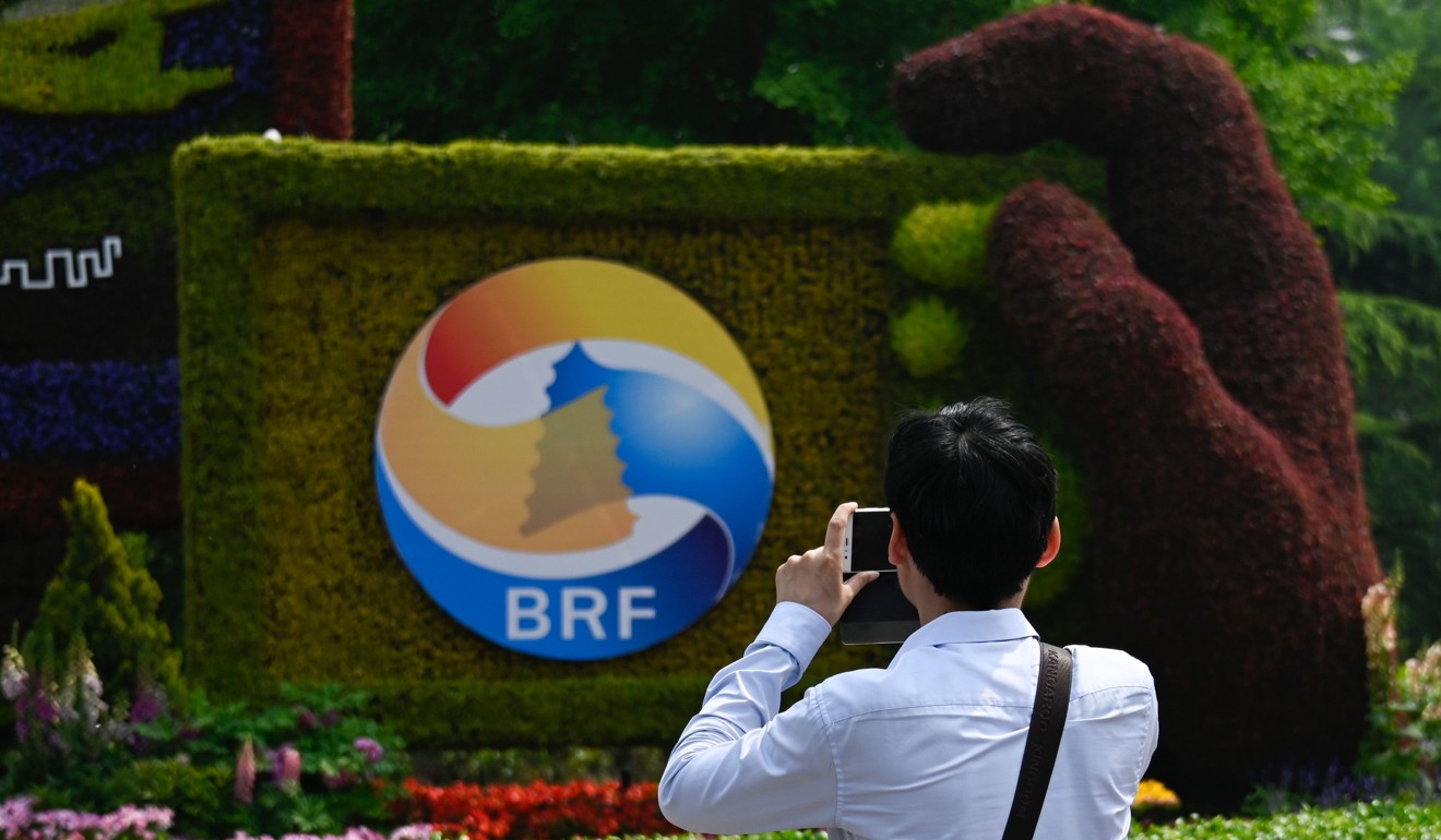 A man takes photo of a sign promoting the Belt and Road Forum in Beijing. Photo: AFP