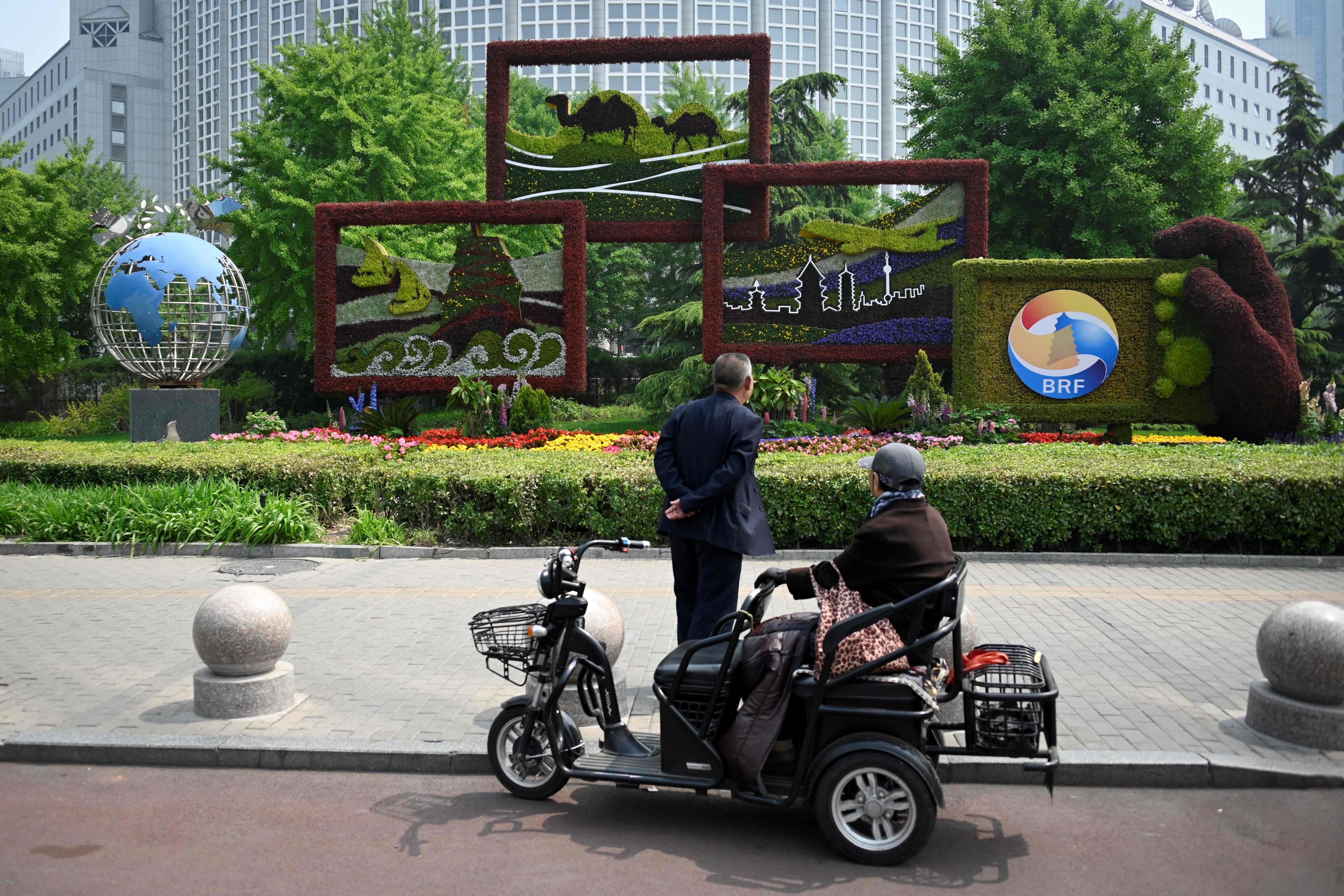 Elderly people stop at a sign promoting the Belt and Road Forum in Beijing. Chinese leaders recognise the plan has run into many unexpected problems overseas. This ongoing backlash should force China to rethink and reset the initiative. Photo: AFP