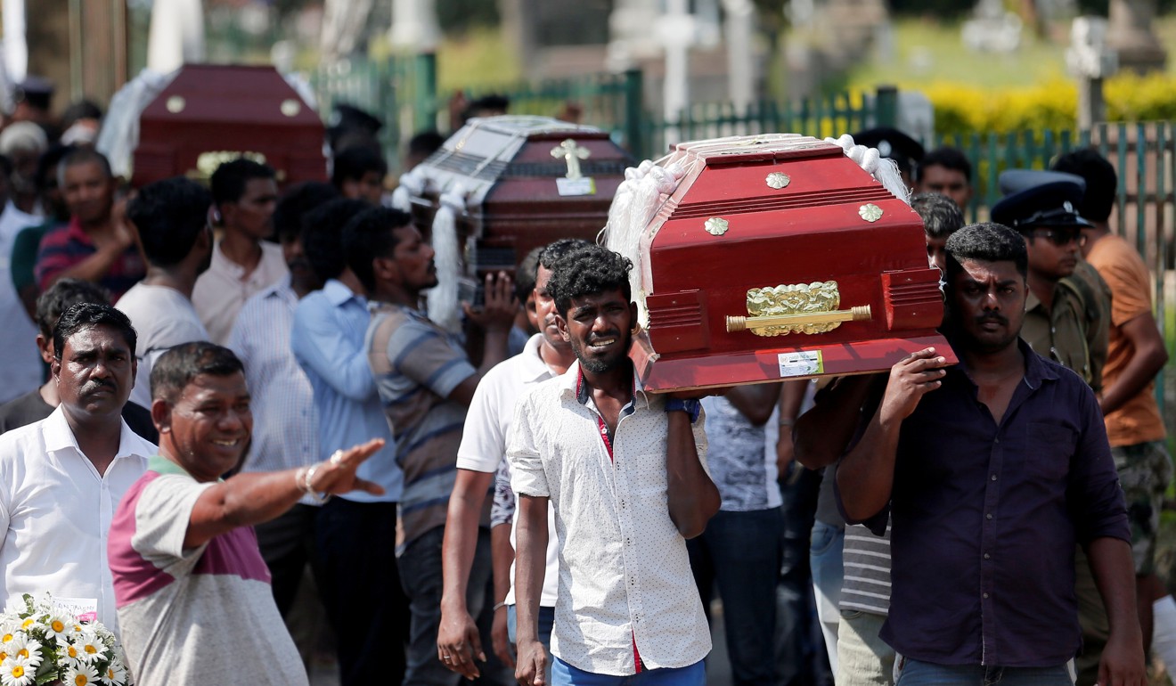 Coffins are carried during a mass for victims on Tuesday. Photo: Reuters