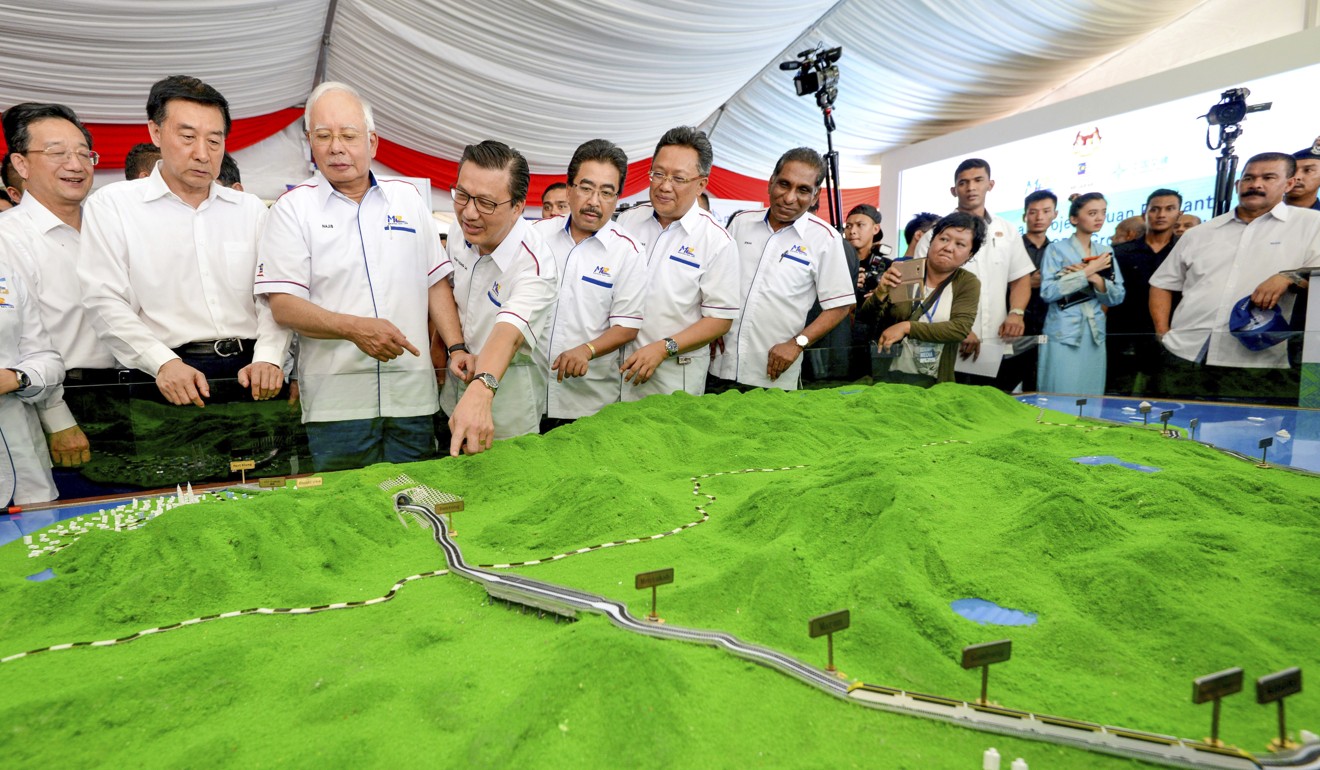 Former Malaysian Prime Minster Najib Razak, third from left, inspects a model of the proposed high-speed rail line. Photo: AP