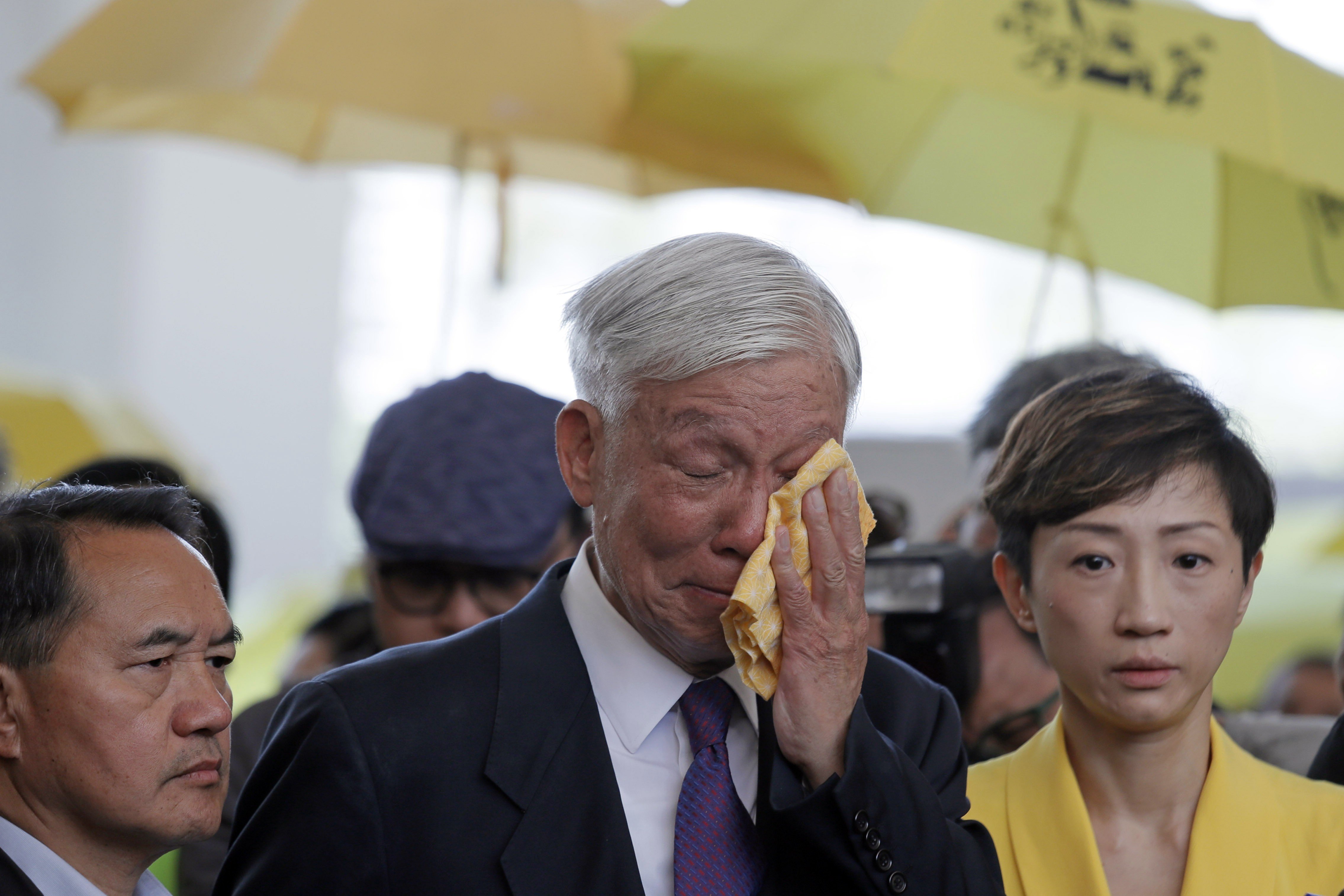 Occupy leader Chu Yiu-ming cries as he speaks to the media after sentencing at a court in Hong Kong on April 24. Eight leaders of massive protests in 2014 were jailed up to 16 months for conspiracy to commit public nuisance. Photo: AP