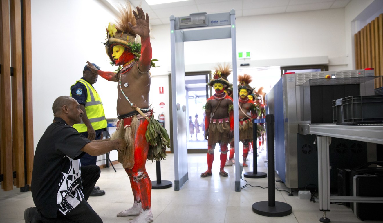 A security officer checks a performer in traditional dress at a security screening at Jacksons International Airport in Port Moresby, Papua New Guinea, ahead of a visit by US Vice-President Mike Pence on November 17, 2018. Enhanced security screening will increasingly become commonplace in hotels, shopping malls and railways stations. Photo: AP