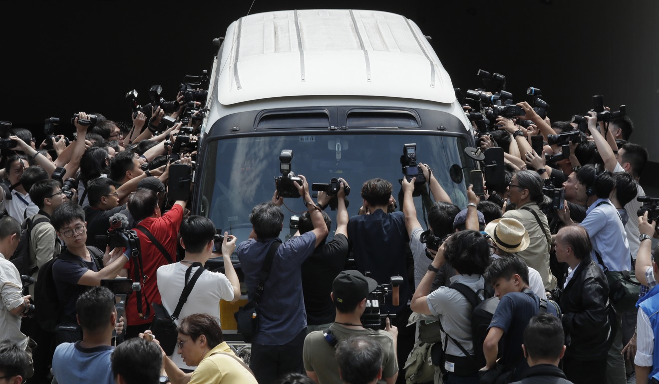 Four of the Occupy leaders are driven away in a prison van on Wednesday. Photo: AP