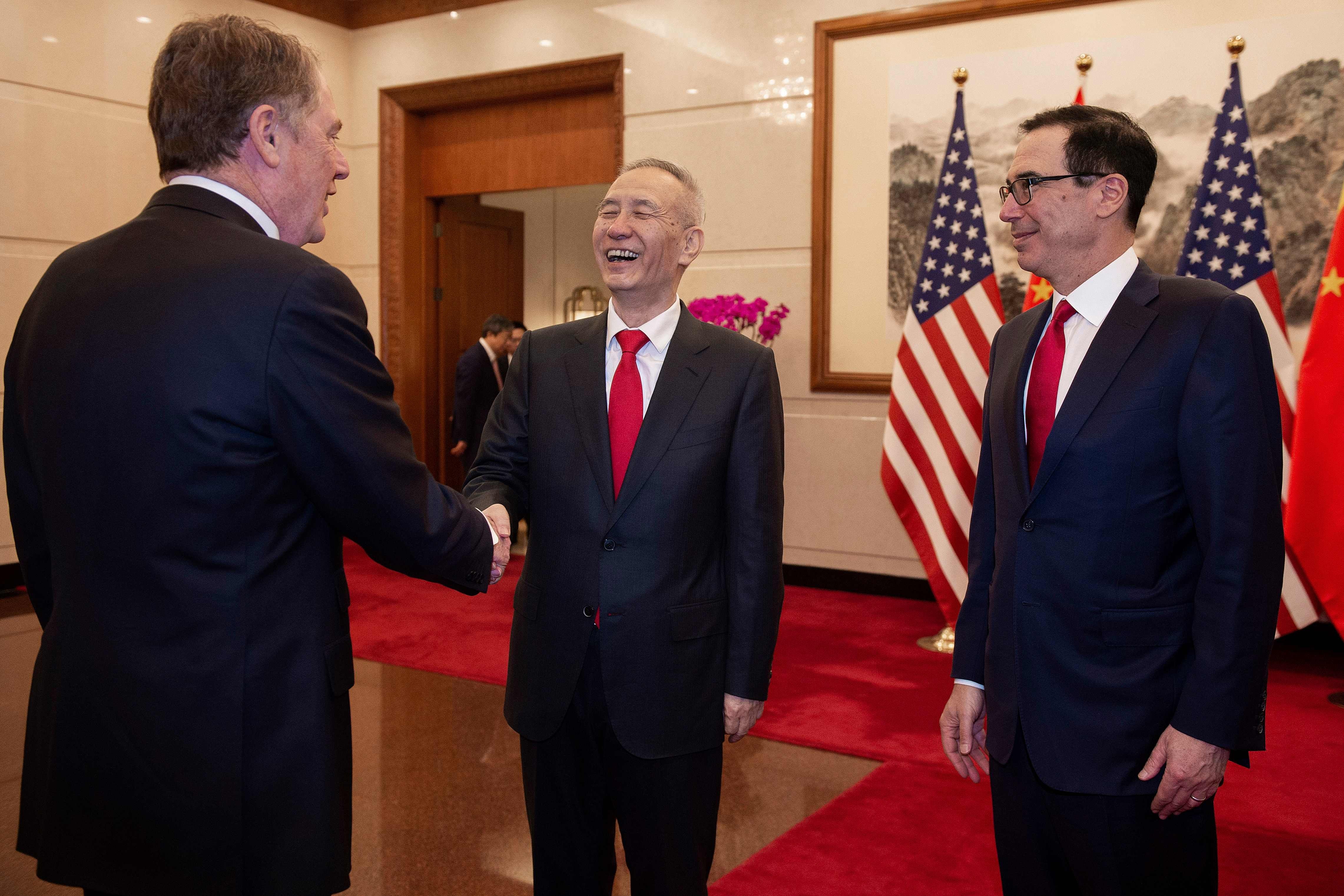 China's Vice Premier Liu He (centre) shake hands with US Trade Representative Robert Lighthizer (left) as US Treasury Secretary Steven Mnuchin (right) looks on in Beijing in March. Photo: AFP