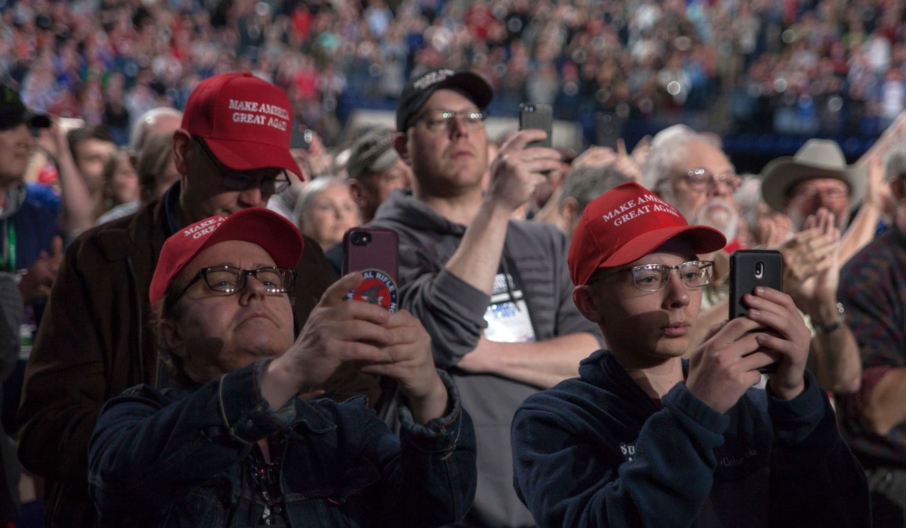 Supporters take pictures and video with their phones as US President Donald Trump makes his entrance at the National Rifle Association Annual Meeting on Friday. Photo: AFP