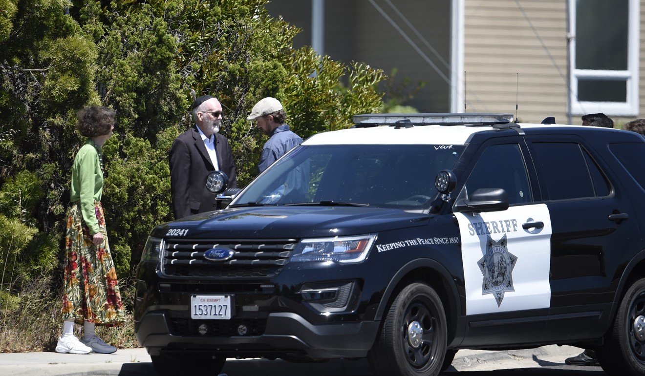Synagogue members stand outside the Chabad of Poway Synagogue. Photo: AP Photo