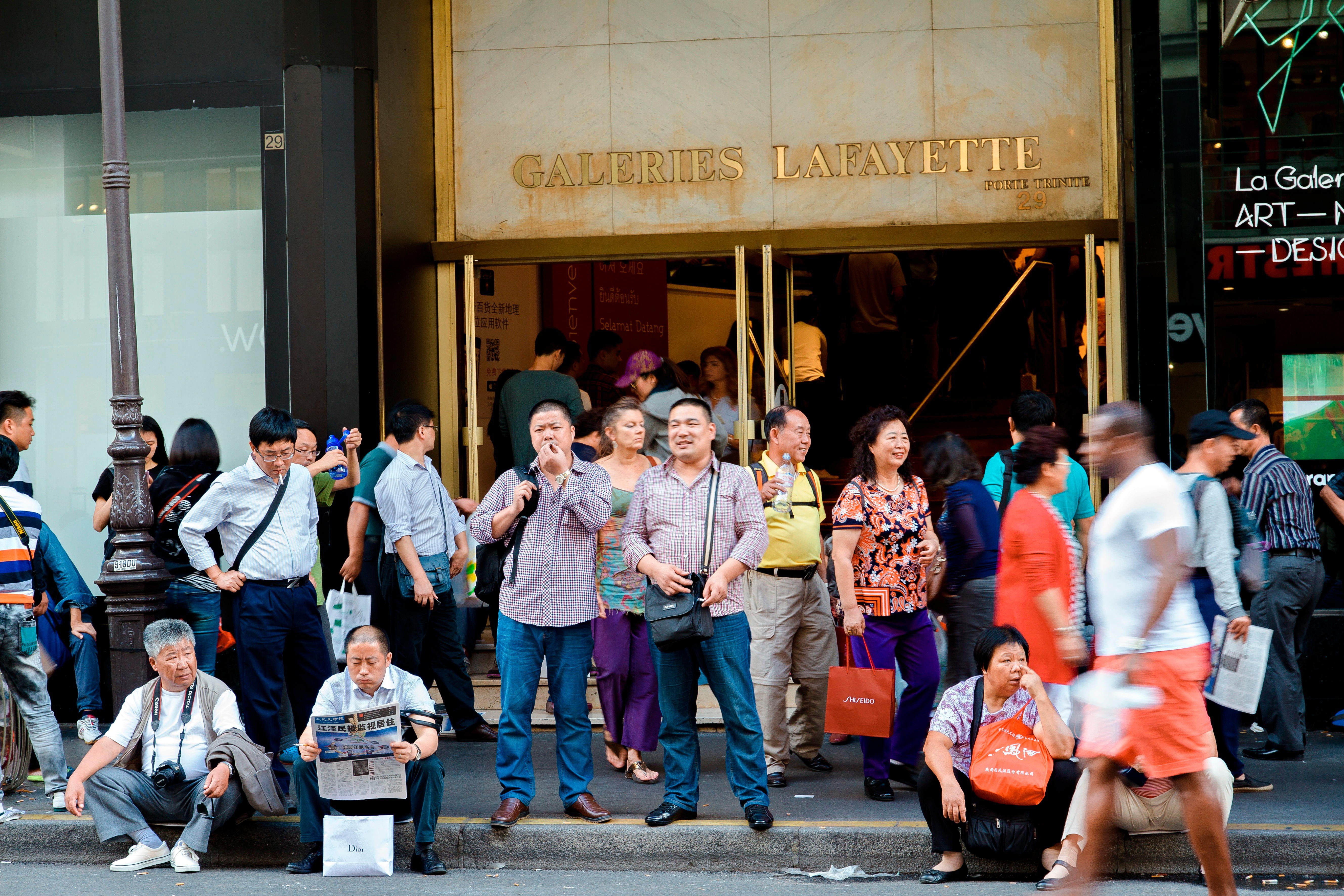 Chinese tourists waiting in front of Galeries Lafayette department store. Photo: Alamy