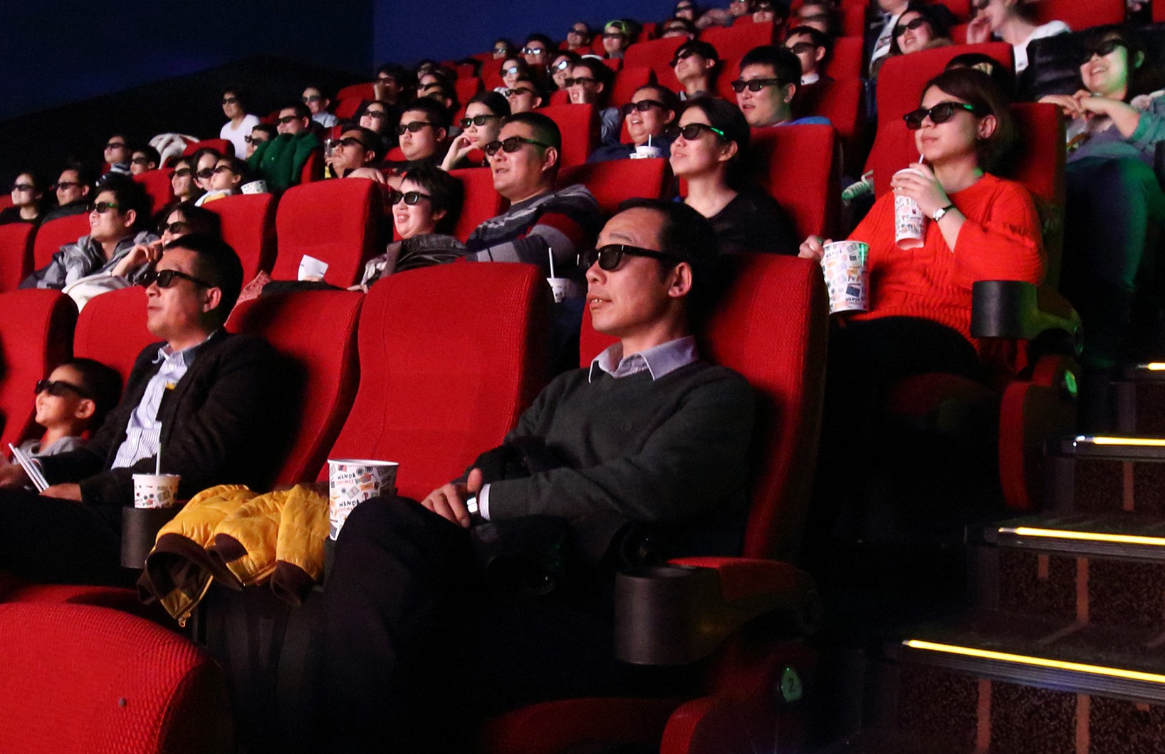 Movie goers with 3-D glasses in a cinema at the Tongzhou Wanda Plaza shopping mall, operated by Dalian Wanda Group, in Beijing on Saturday, March 14, 2015. Photo: Bloomberg