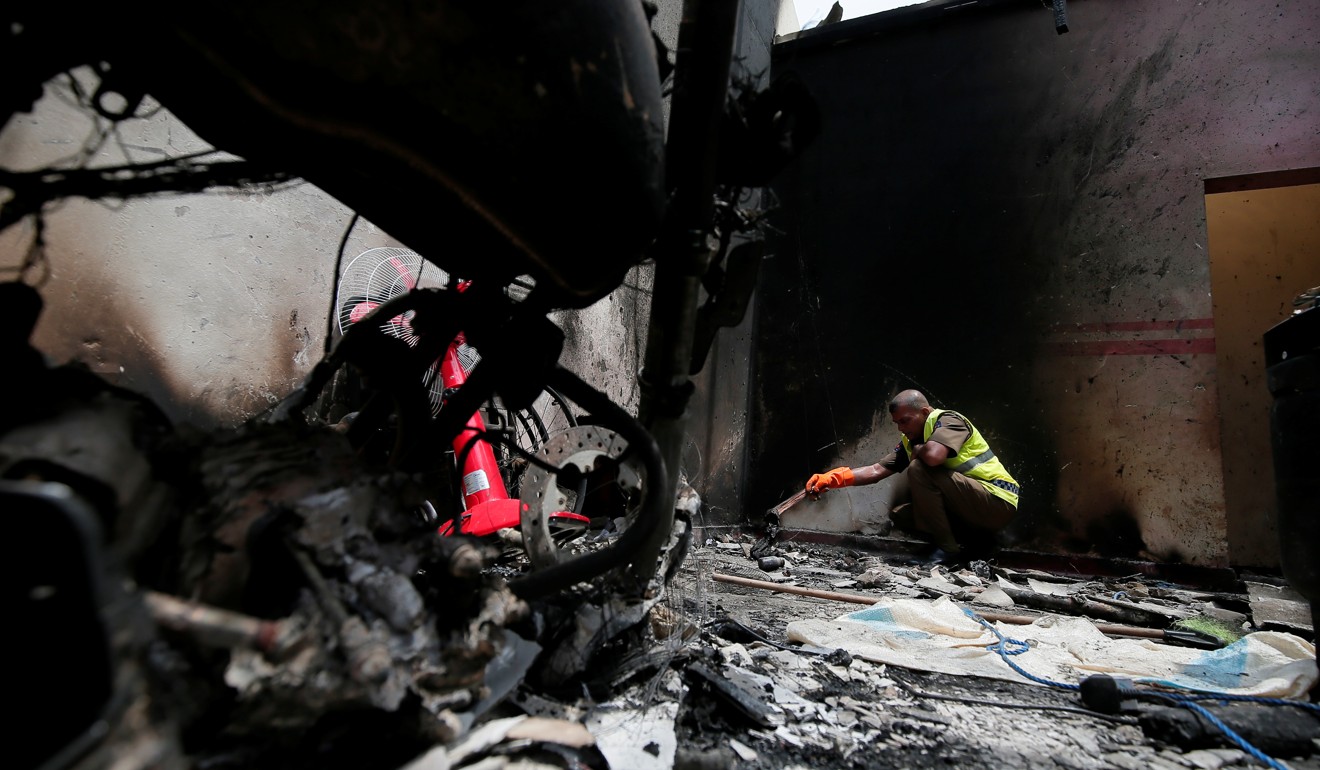A police officer inspects the site of Friday’s carnage in Kalmunai. Photo: Reuters