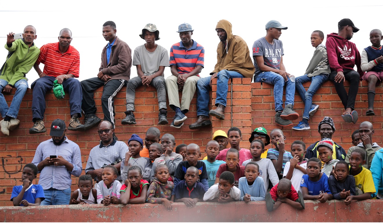 Residents of Alexandra township listen as Ramaphosa addresses a rally. Photo: Reuters