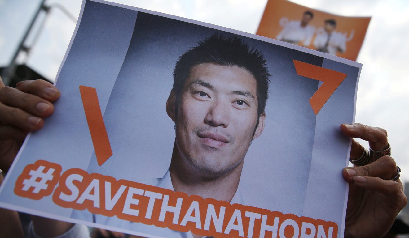 A supporter holds up a placard with the #SaveThanathorn hashtag. Photo: Reuters