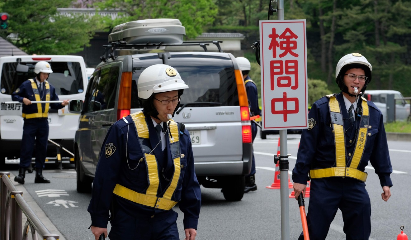 Policemen at a security checkpoint on a road near the Imperial Palace in Tokyo. Photo: AFP