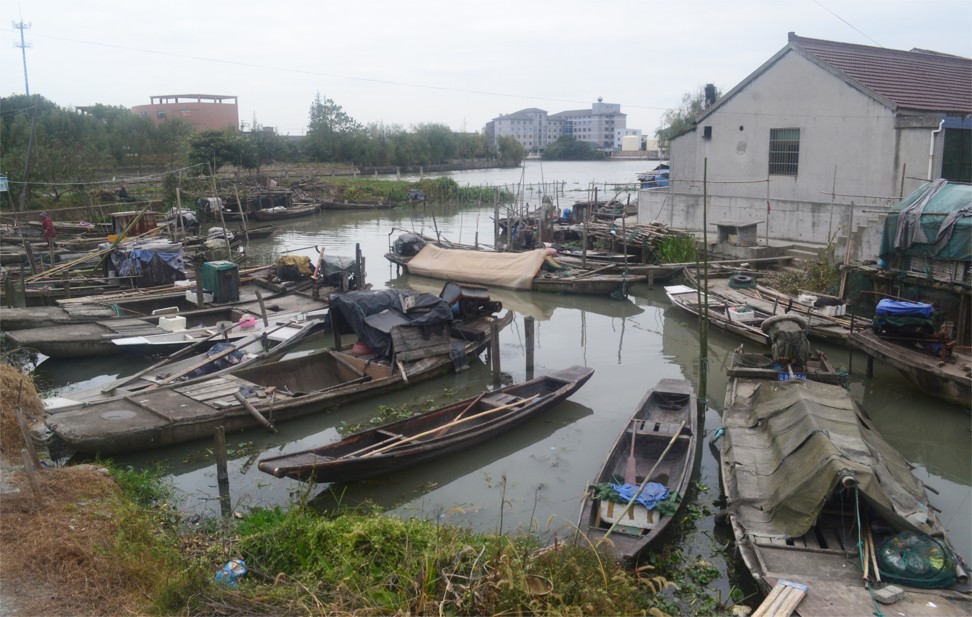 Fishing boats line the riverbank in Yucheng, Zhejiang province. Yucheng, the town government, which wants to turn it into a one-stop market for adult products, signed a 10 billion yuan (US$1.5 billion) deal with a Chinese company to develop a “Happy Town” that will include a sex toy shopping street, a sex exhibition centre and an “adult-only” hotel. Photo: Sidney Leng