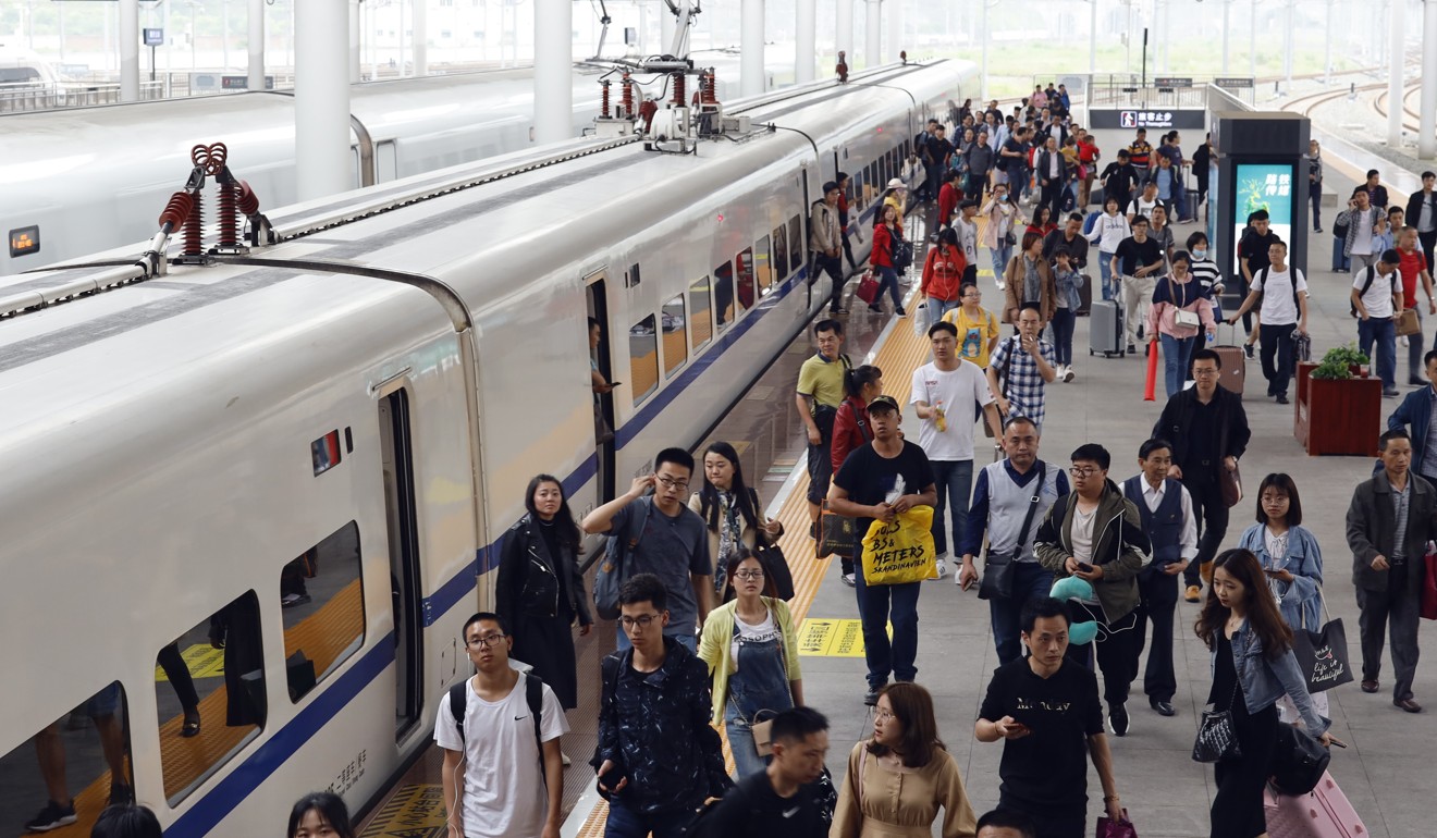 Passengers board the train at Chongqing North Railway Station in southwest China on Tuesday, hoping to beat the May holiday travel rush. Photo: Xinhua