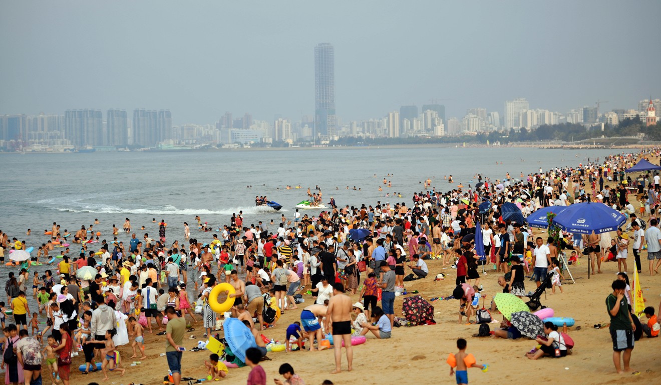 Tourists enjoy the first day of China’s four-day May holiday on a beach in Haikou, Hainan province, southern China. Photo: Xinhua