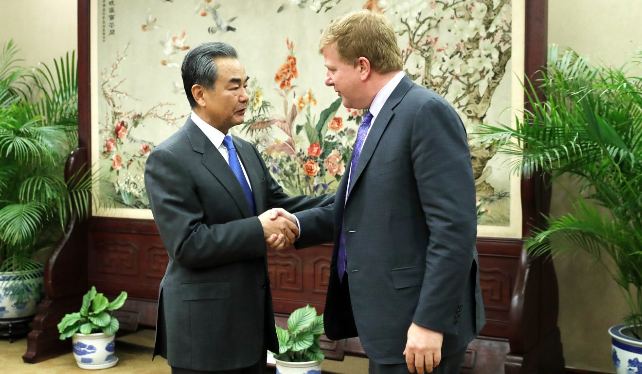 Myron Brilliant (right), head of international affairs at the US Chamber of Commerce, shakes hands with Chinese Foreign Minister Wang Yi in February. Photo: EPA-EFE
