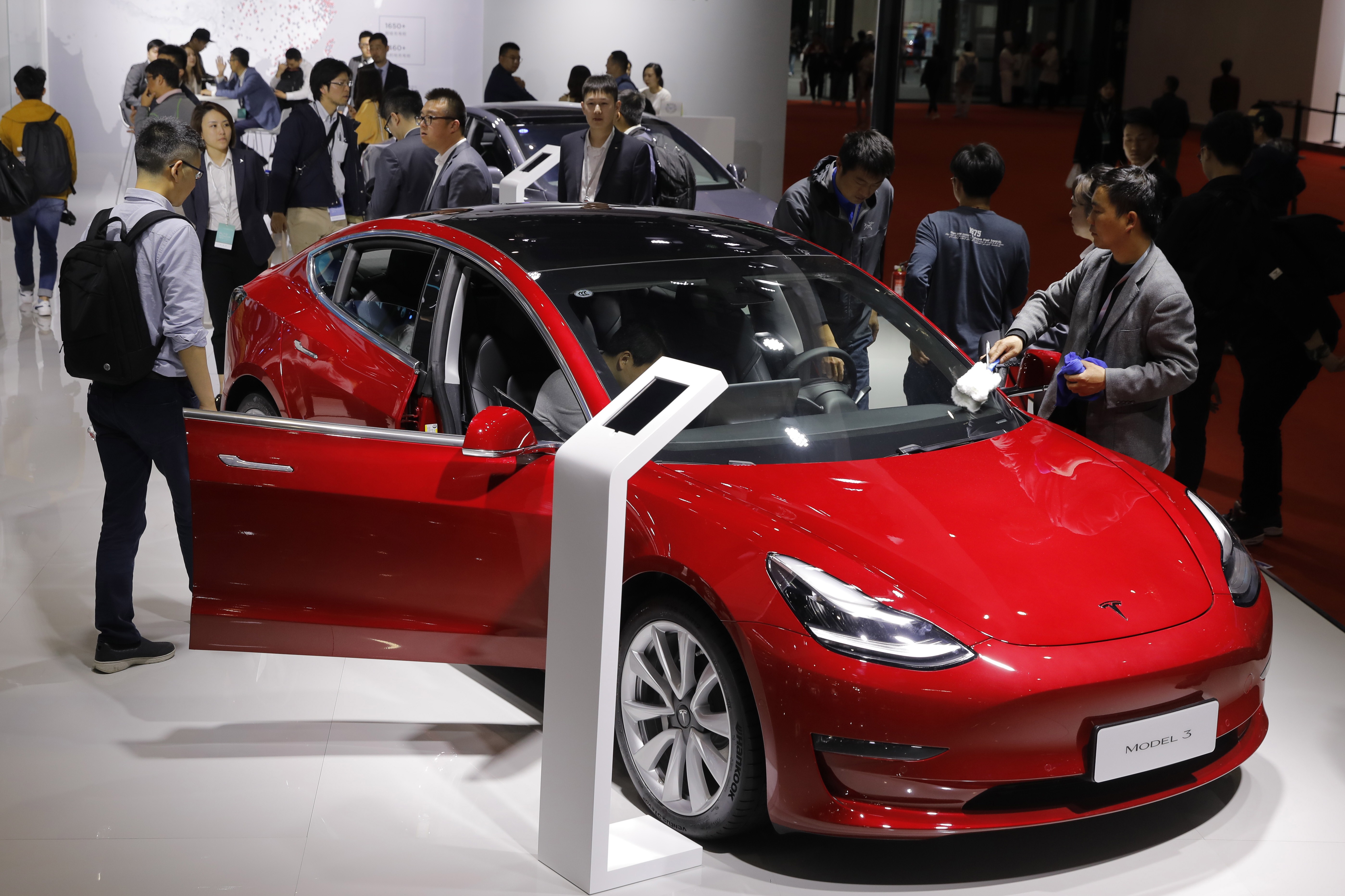 People visit a Tesla booth at the Auto Shanghai motor show on April 16. Photo: Reuters