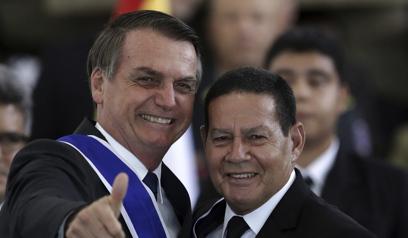 Brazil's President Jair Bolsonaro flashes a thumbs up after bestowing the insignia of the Order of Rio Branco to Vice President Hamilton Mourao, right, during a ceremony to commemorate Diplomat Day. Photo: AP Photo