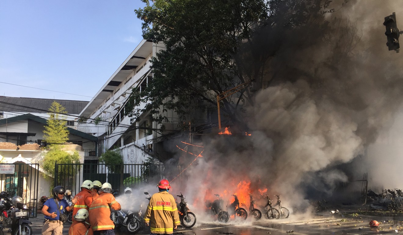Firefighters trying to put out a fire after a suicide bombing in Surabaya in May 2018. Photo: AFP