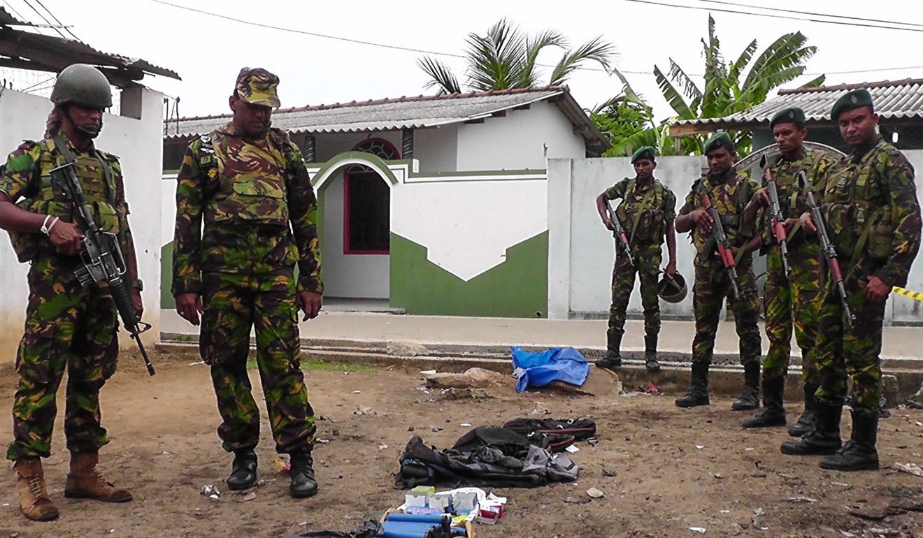 Soldiers look at seized items at the site of an overnight battle between Sri Lankan security forces and suicide bombers in the eastern town of Kalmunai, Sri Lanka. Photo: AFP