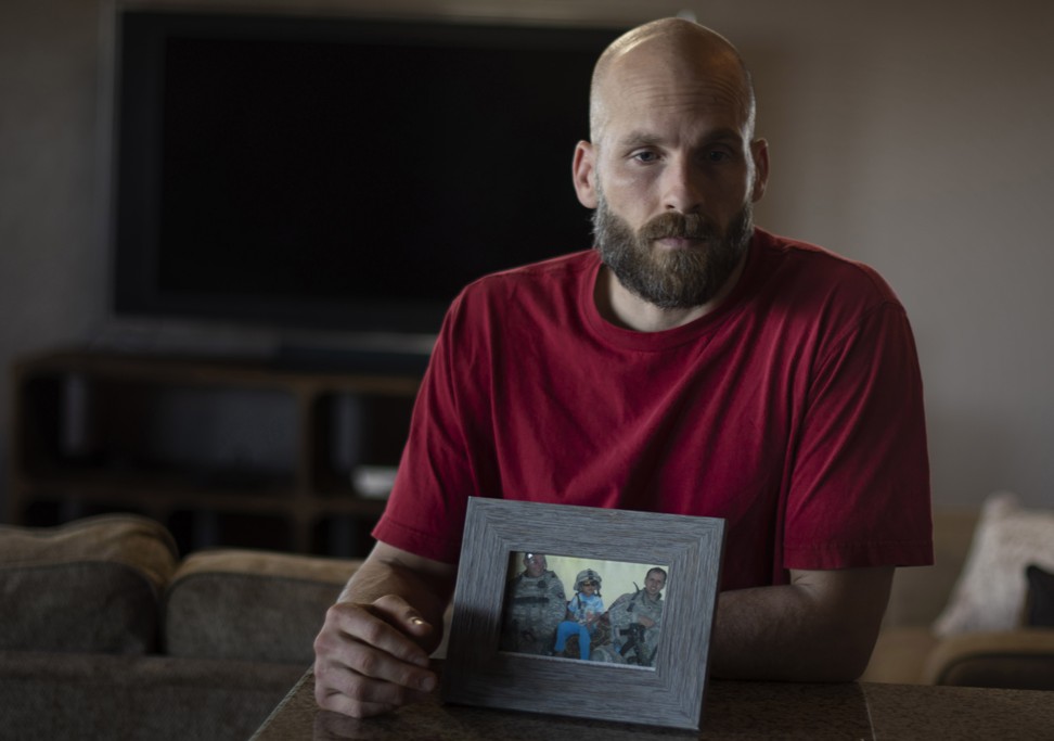 Behenna with a photo of two comrades who were killed by a roadside bomb in Iraq in 2008. Photo: The Washington Post