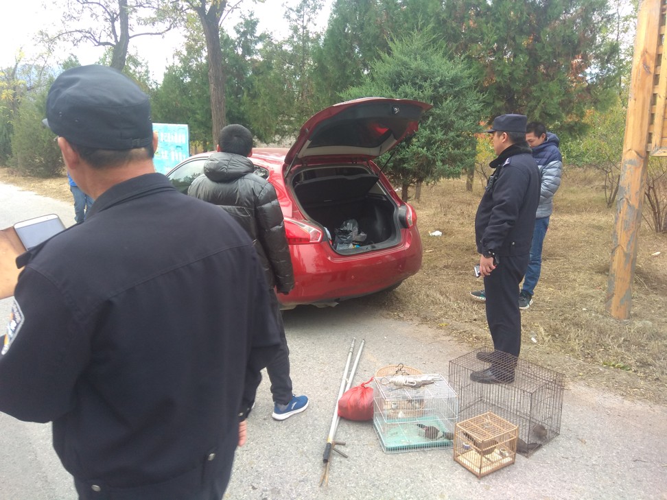 Two poachers are apprehended in the park after Gu alerts the authorities. Photo: Silva Gu