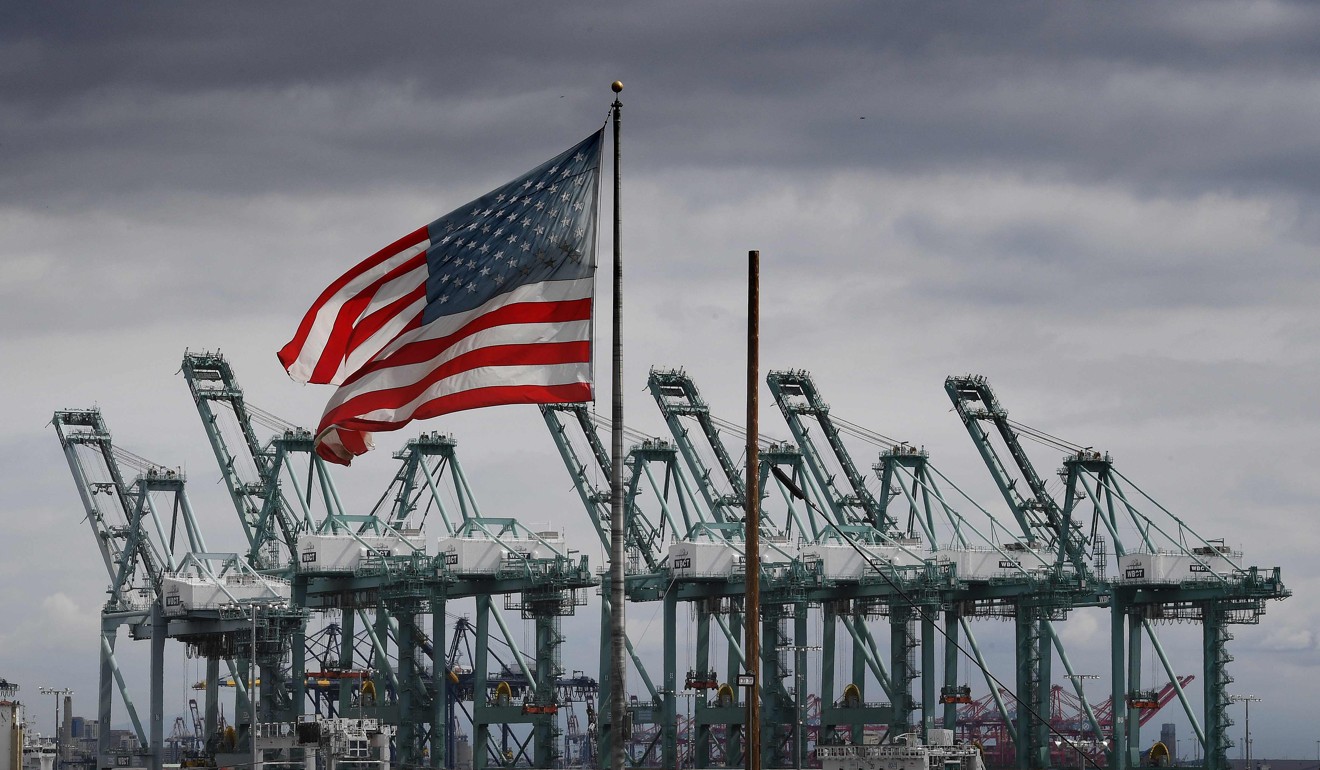 Gou says Washington is striving to build or reshape its supply chain ahead of an impending technology war with China. Pictured, an American flag flies over shipping cranes and containers. Photo: AFP