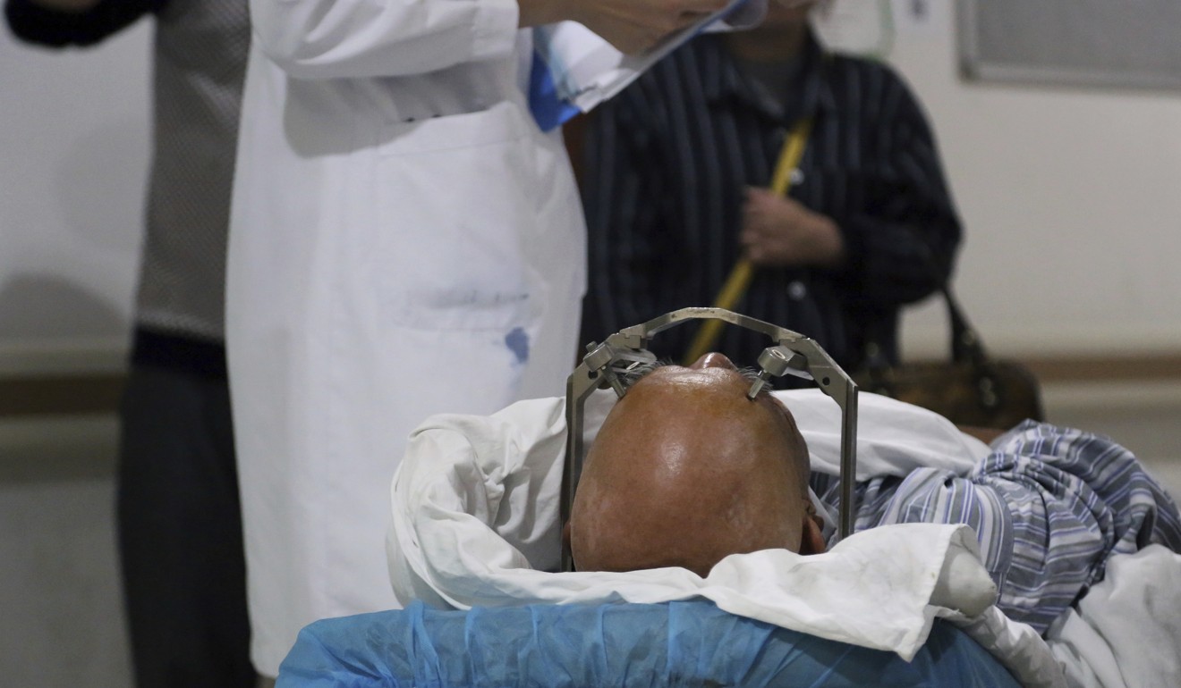 A stereotactic device presses into the head of a brain surgery patient at Ruijin Hospital. Photo: AP