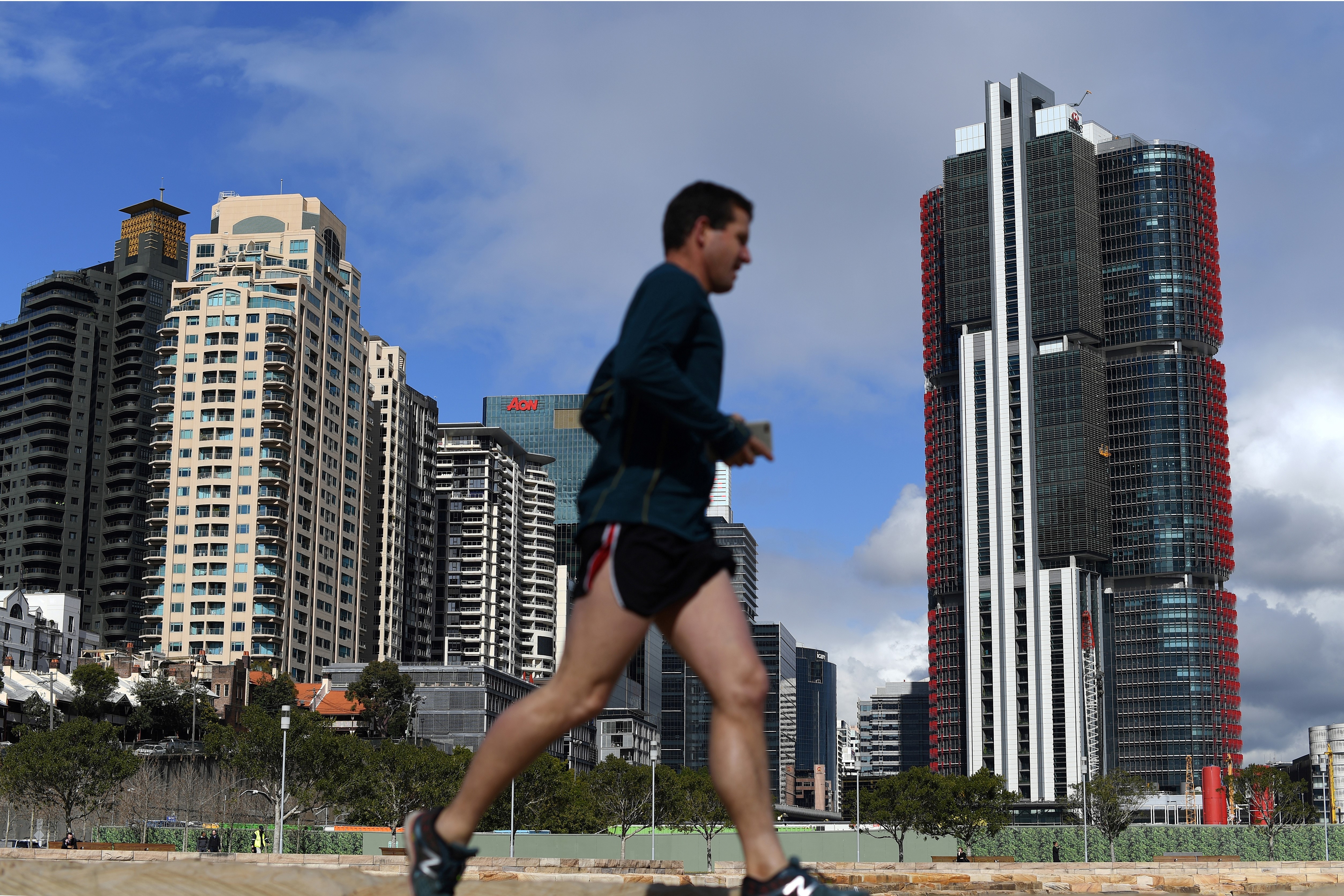 The Australian Competition and Consumer Commission said on Wednesday ‘it has decided to oppose the proposed merger’ between Vodafone Hutchison Australia and TPG Telecom. A jogger in front of newly constructed residential and commercial projects in Sydney. Photo: AFP