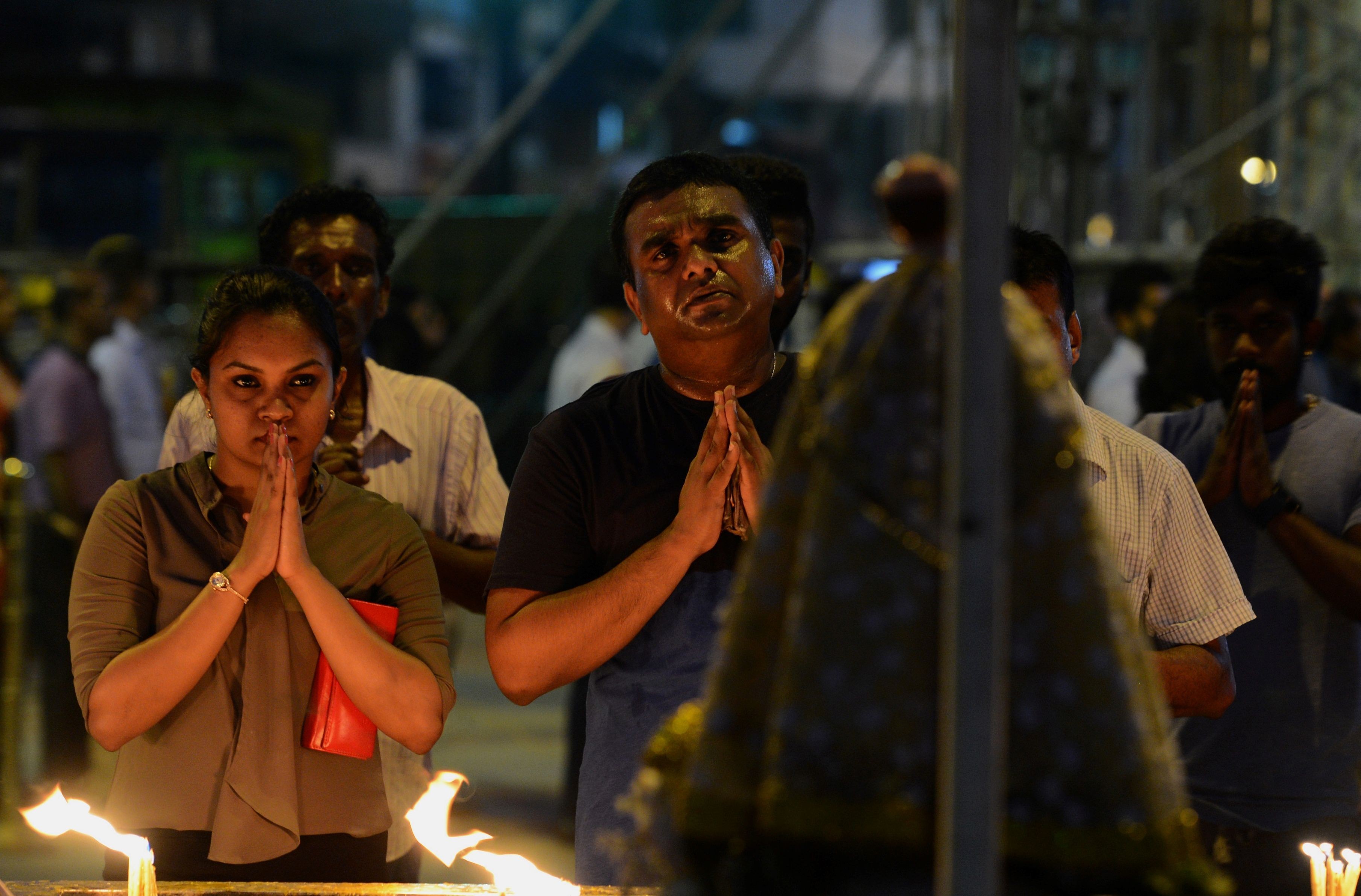 Sri Lankan Catholic devotees pray at St Anthony’s church after it was partially opened. Photo: AFP