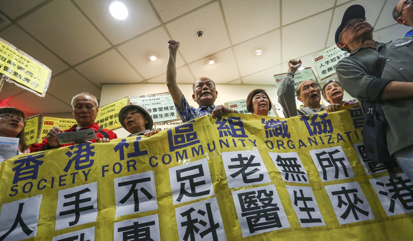Protesters make their voices heard at the meeting venue. Photo: Jonathan Wong