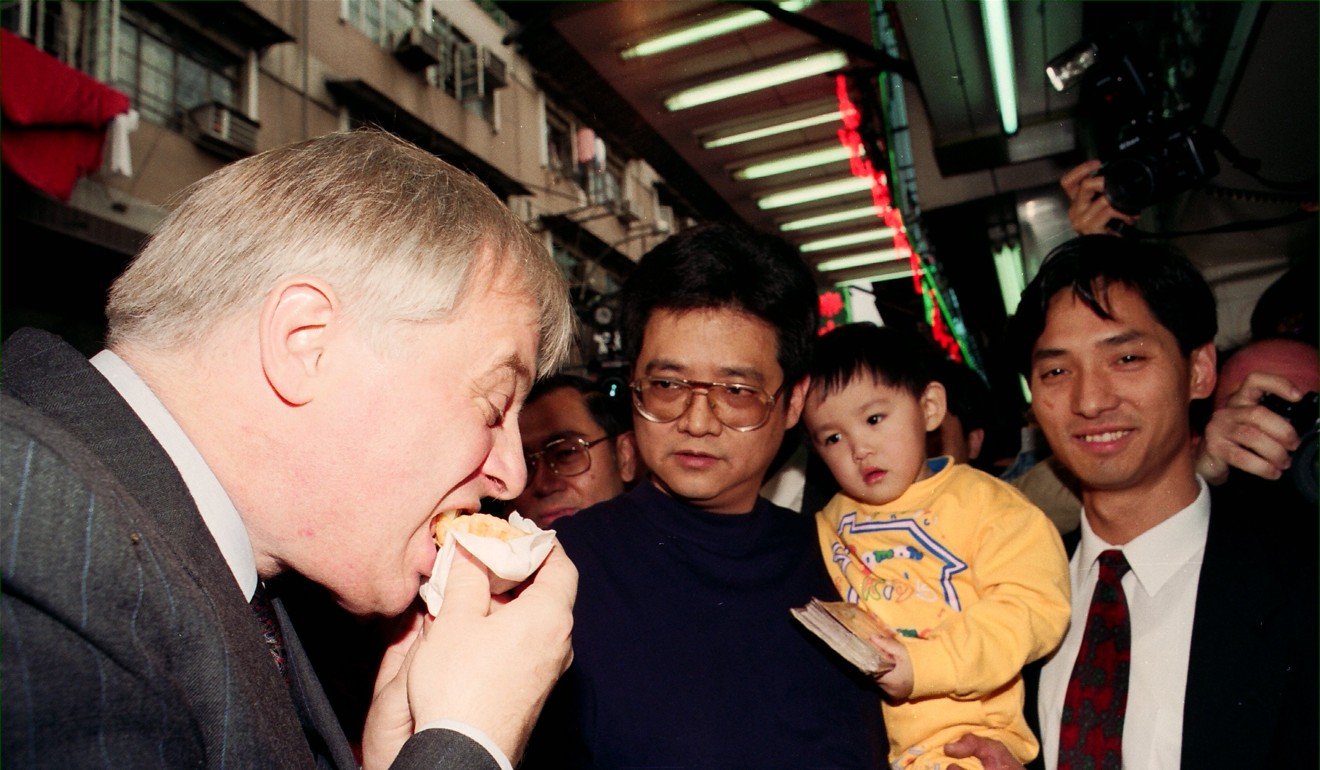 Chris Patten, who was the colonial governor of Hong Kong from 1992 to 1997, tries an egg tart during a visit to Sha Tau Kok. Photo: SCMP