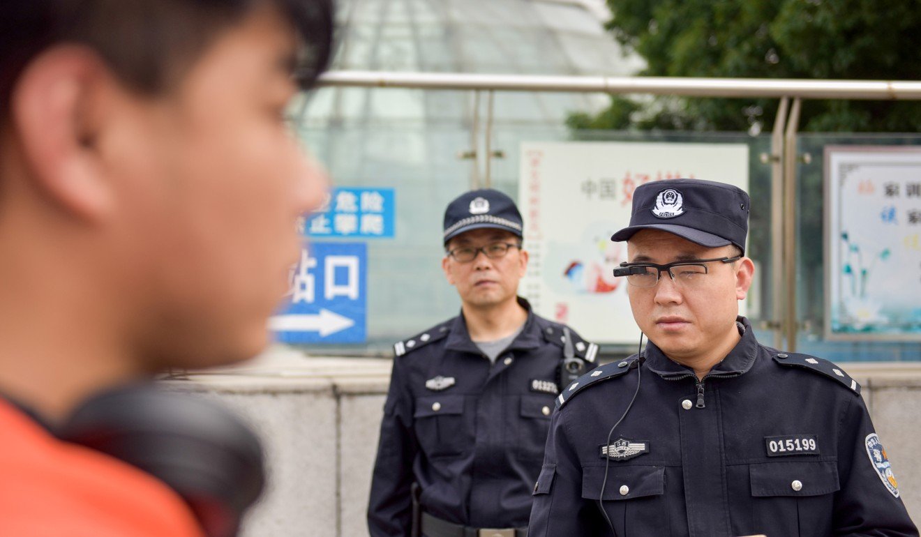A police officer wearing AI-powered smart glasses patrolling on a street in Nanchang, China on May 5. Photo: Reuters