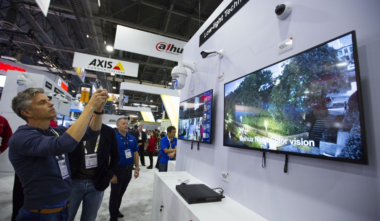 A visitor takes photos at the booth of Dahua Technology at the International Security Conference and Exposition in Las Vegas on April 10. Photo: Xinhua