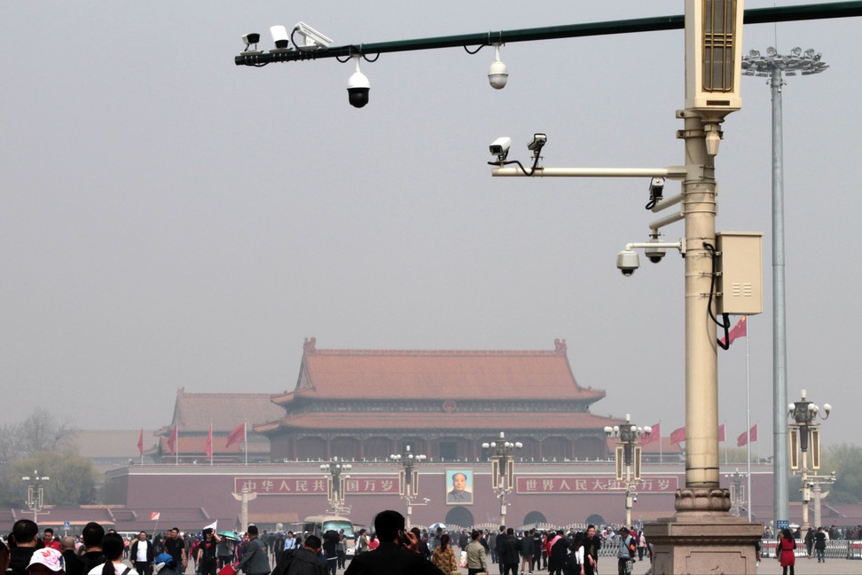 Tourists walk on Tiananmen Square, beneath the gaze of security cameras, in March 2018. Photo: Simon Song