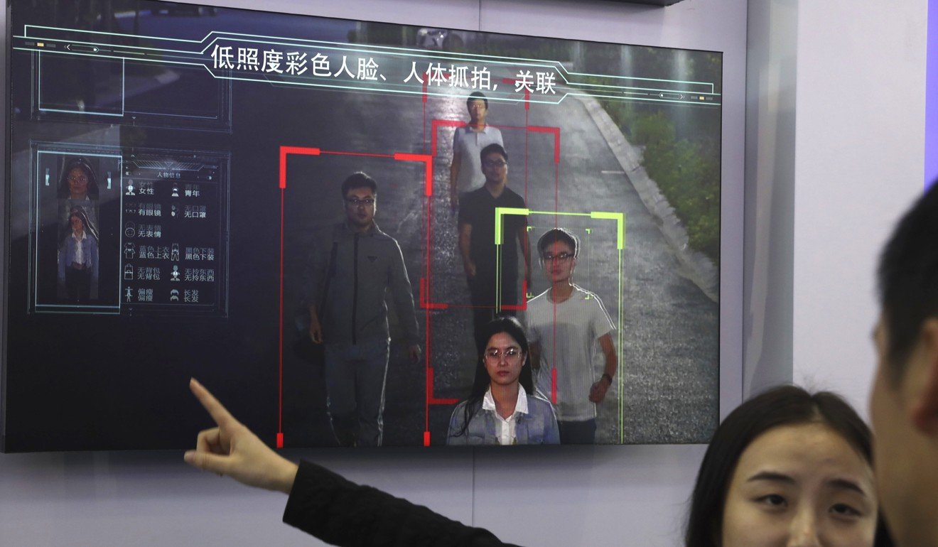 A sales person introduces human identification technology from surveillance equipment manufacturer Hikvision on a monitorin Beijing last year. Photo: AP