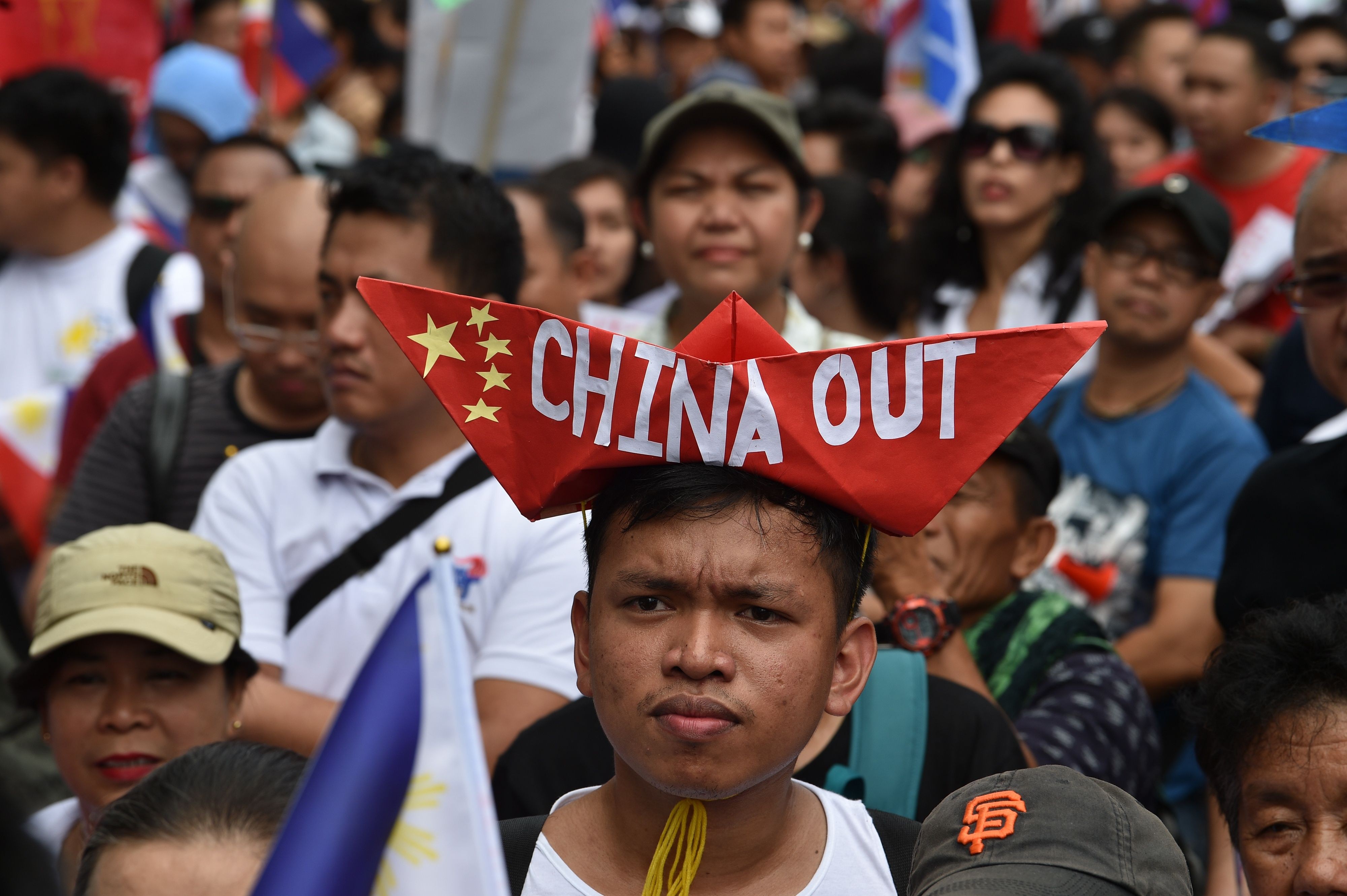 Anti-China protesters chant slogans in front of the Chinese embassy in the financial district of Manila on April 9. Photo: AFP