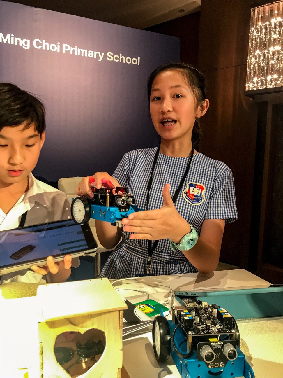 A Primary Six student from Baptist (Sha Tin Wai) Lui Ming Choi Primary School with her robot at the Apple Education Summit. Photo: Michelle Wong