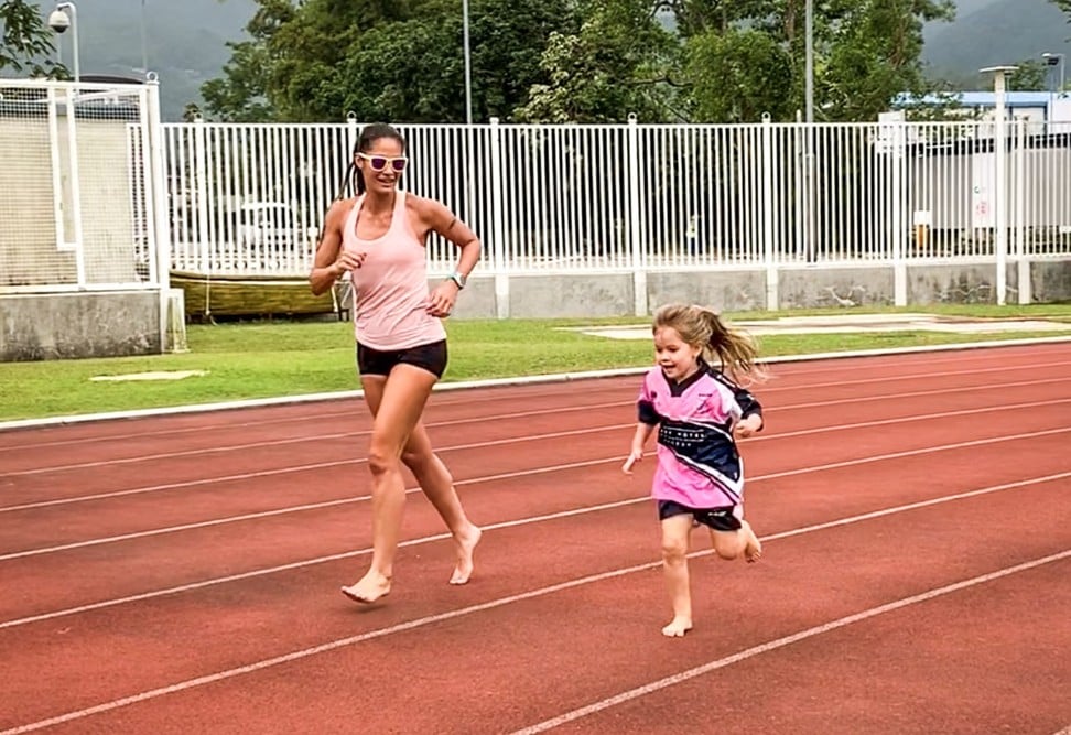Danielle and Angelie running at the track in Hong Kong.