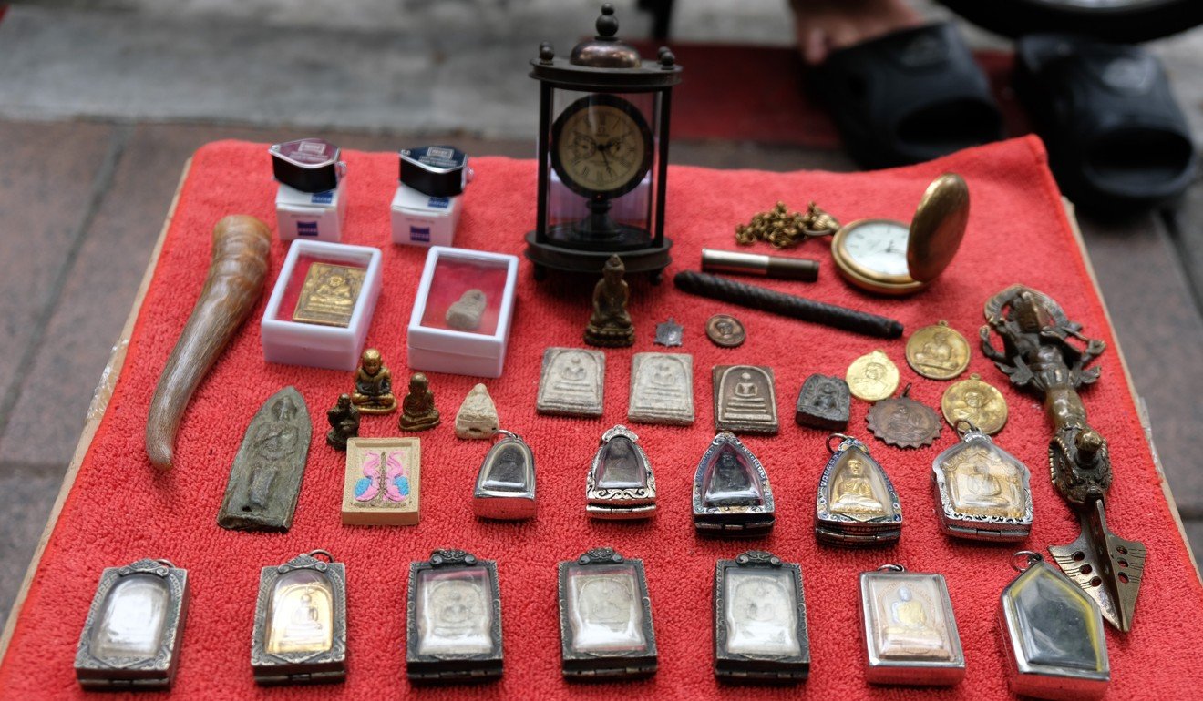Amulets for sale at a Bangkok amulet market. Some, like these, are laid out in neat rows, others are jumbled together. Photo: Tibor Krausz